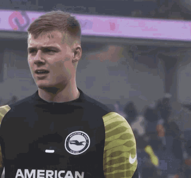 a soccer player wearing an american shirt looks at the camera