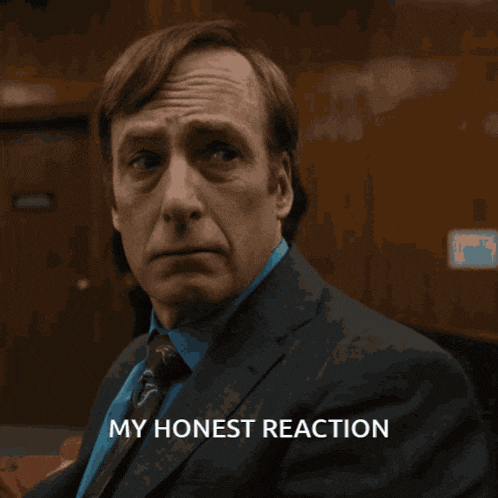 a man in a suit and tie with the words " my honest reaction " above him