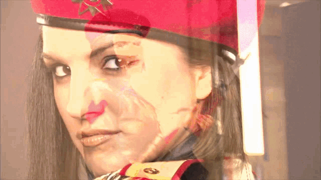 a woman wearing a red beret with a gold star on it