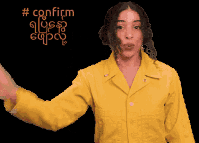 a woman in a yellow jacket is pointing at something with the words confirm written in red