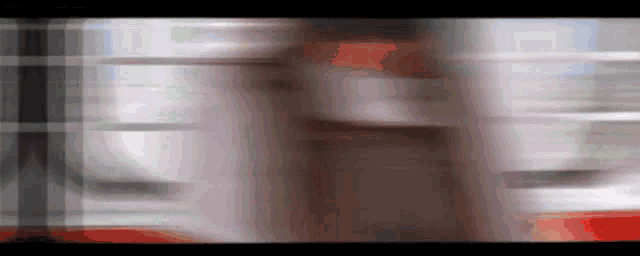 a blurry picture of a person 's face with a red stripe on it