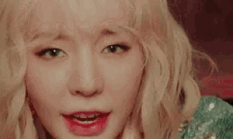 a close up of a woman 's face with blonde hair .