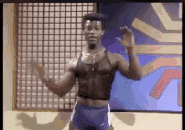 a man is dancing in a room with his arms outstretched .