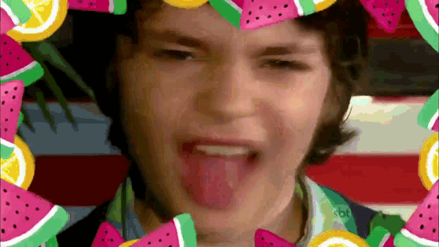 a man is sticking his tongue out in front of a watermelon frame