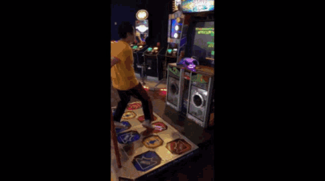 a person is playing a dance game in an amusement arcade
