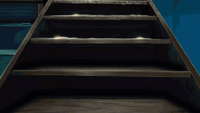 a cartoon character laying on a wooden staircase with a blue background