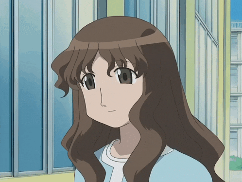 a girl with long brown hair and a white shirt is smiling