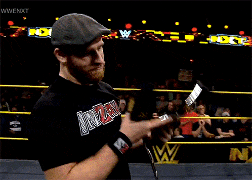 a wrestler wearing a black shirt that says inz on it