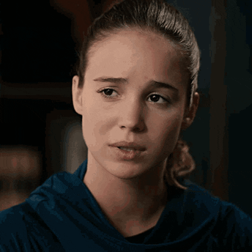 a woman says " i 'm sorry for your pain " while making a sad face
