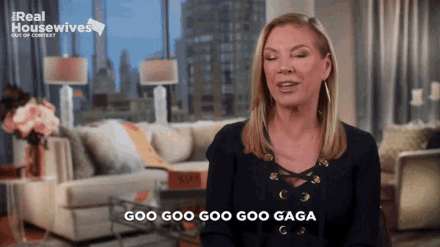 a woman says goo goo goo goo gaga in front of a living room