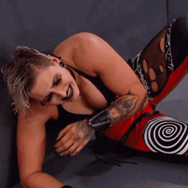 a woman with a tattoo on her arm is laying down