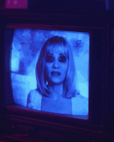 a woman 's face is displayed on a television screen with a blue background