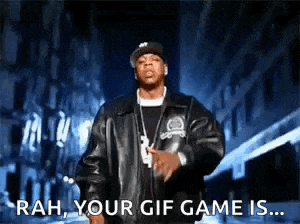 a man in a leather jacket is standing in front of a building and says " rah your gif game is "
