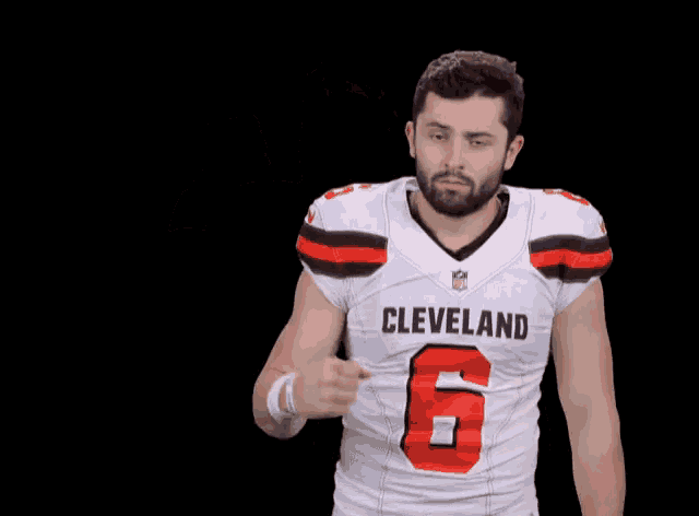 a man in a cleveland football jersey flexes his muscles