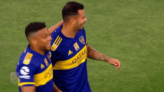 a soccer player wearing a number 18 jersey is hugging another player