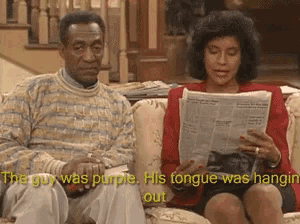 a man and a woman are sitting on a couch reading a newspaper and the man says he was purple