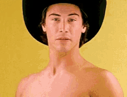 a shirtless man wearing a black cowboy hat on a yellow background