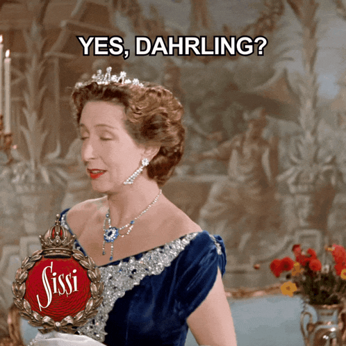 a woman wearing a blue dress and a tiara says " yes dahrling "
