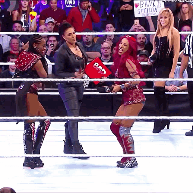 women in a wrestling ring with a sign that says bank section