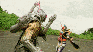 two kamen riders are fighting each other on a road .