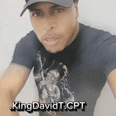a man wearing a hat and a t-shirt that says king davidt cpt