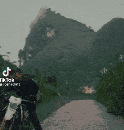 a man is riding a dirt bike on a road with the words hey r name on the bottom