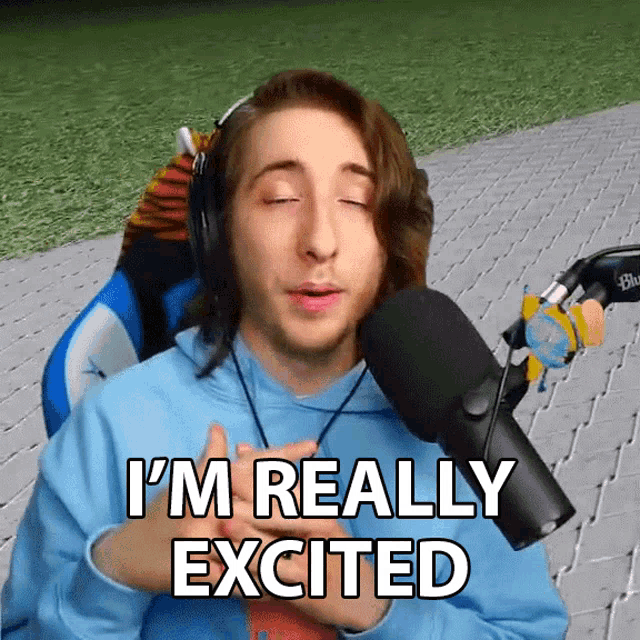 a man wearing headphones and a blue shirt says i 'm really excited