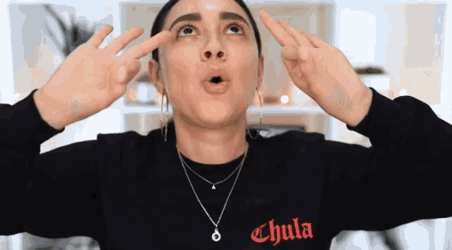 a woman wearing a black shirt with chula written on it