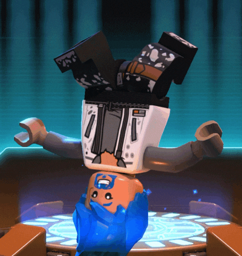 a lego figure is doing a handstand and has a superhero on his head
