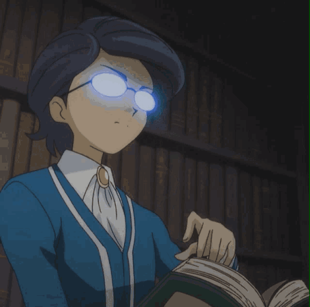 a man wearing glasses is reading a book in a dark room