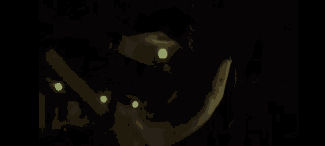 a man with a beard is holding a flashlight in the dark