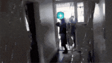 a blurred image of a person in a hallway