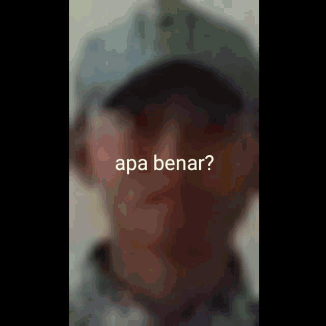 a blurry picture of a man wearing a hat and sunglasses with the words apa benar on the bottom