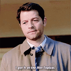 a man in a trench coat and tie says i got it at the hot topical
