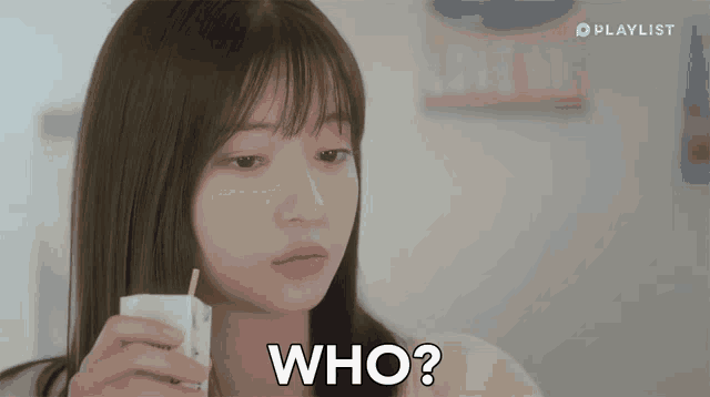 a woman is holding a carton of milk and the word who is on her face