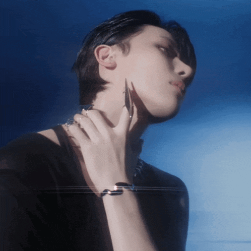 a close up of a person 's face with their hand on their chin