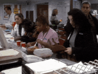 a woman in a pink scrub top has the word nurse on her name tag