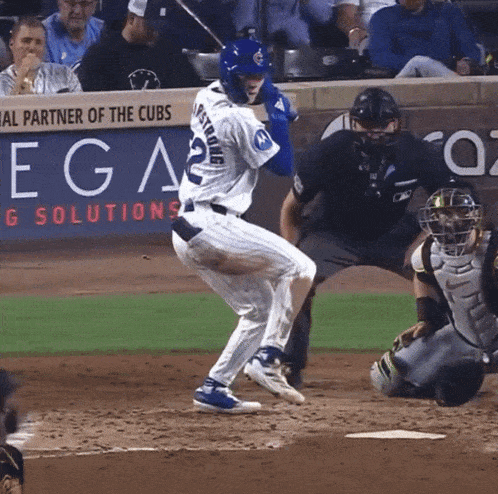 a baseball player with the number 22 on his jersey is swinging at a pitch
