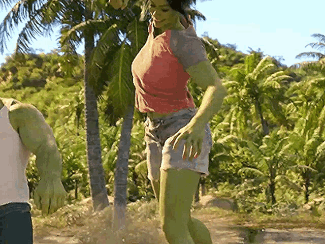a woman with green arms and legs is standing next to a man