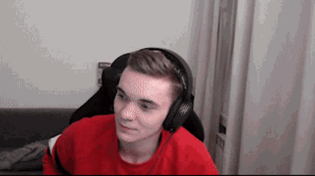 a man wearing headphones is sitting in a chair