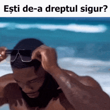 a man wearing sunglasses on the beach with the words esti de-a dreptul sigur written below him