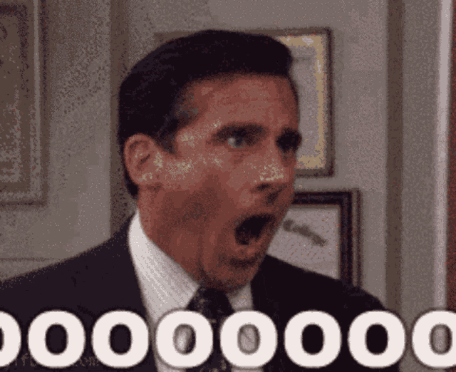 a man in a suit and tie with his mouth wide open and the word 000000 written below him