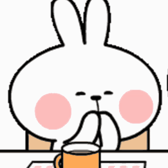 a cartoon rabbit is sitting at a table with a cup of coffee in front of it .
