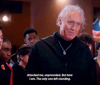 a man with gray hair and a black jacket says " attacked me unprovoked but here i am the only one left standing "