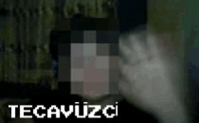 a blurry picture of a person 's face with the words tecavüzci written above it