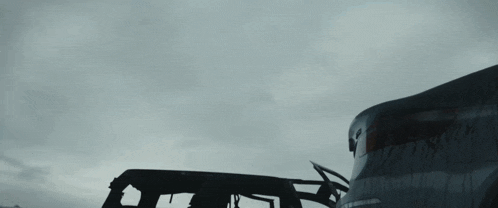 a shadow of a person flying over a car