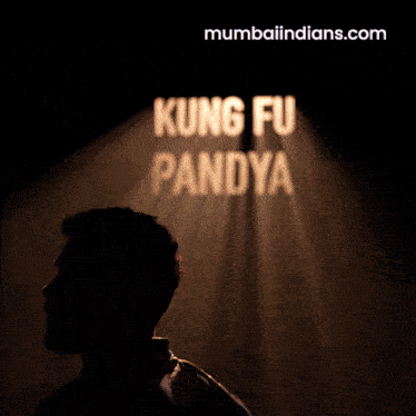 a man stands in front of a sign that says kung fu panda