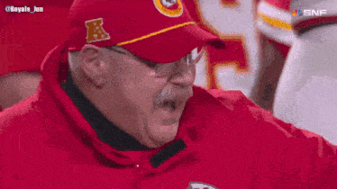 a man wearing a chiefs hat and jacket