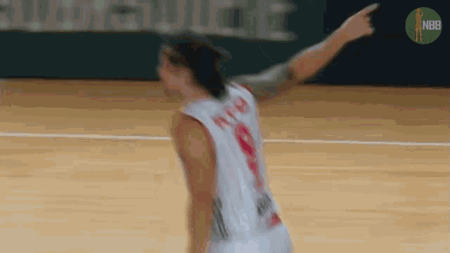 a basketball player with the number 9 on his back is pointing