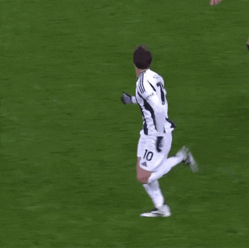 a soccer player with the number 70 on his jersey kicks the ball